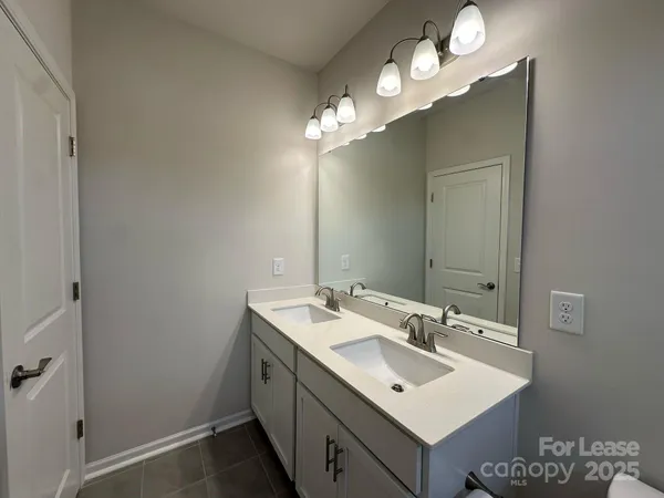 a bathroom with a sink vanity and a mirror
