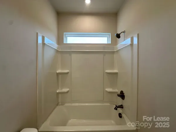 a bathroom with a bathtub and shower