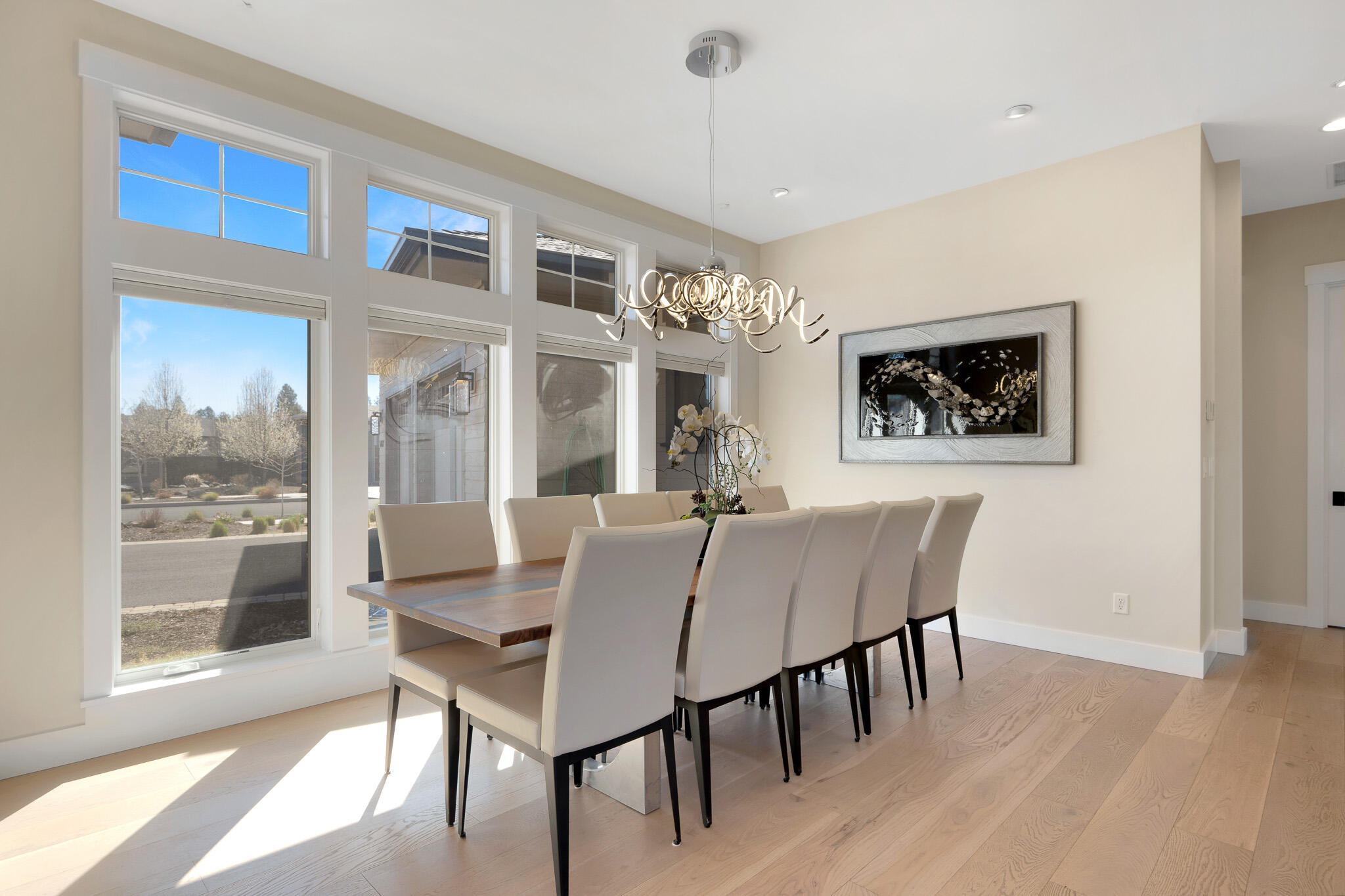 60871 River Rim Drive Bend, OR 97702 - Photo 21 of 42 a view of a dining room with furniture large window and wooden floor