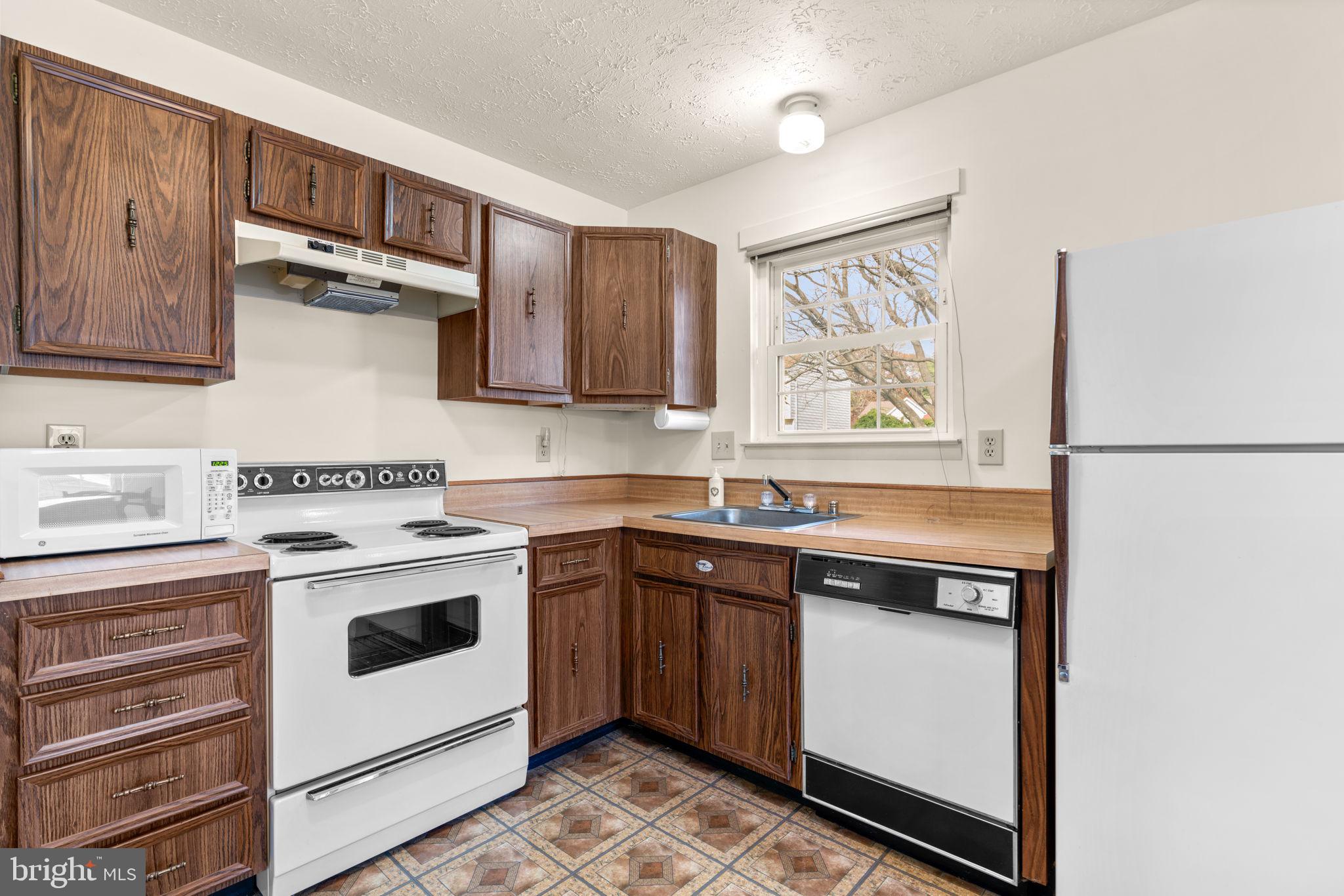 1818 Lasalle Place Severn, MD 21144 - Photo 11 of 30 a kitchen with stainless steel appliances granite countertop a stove and a refrigerator