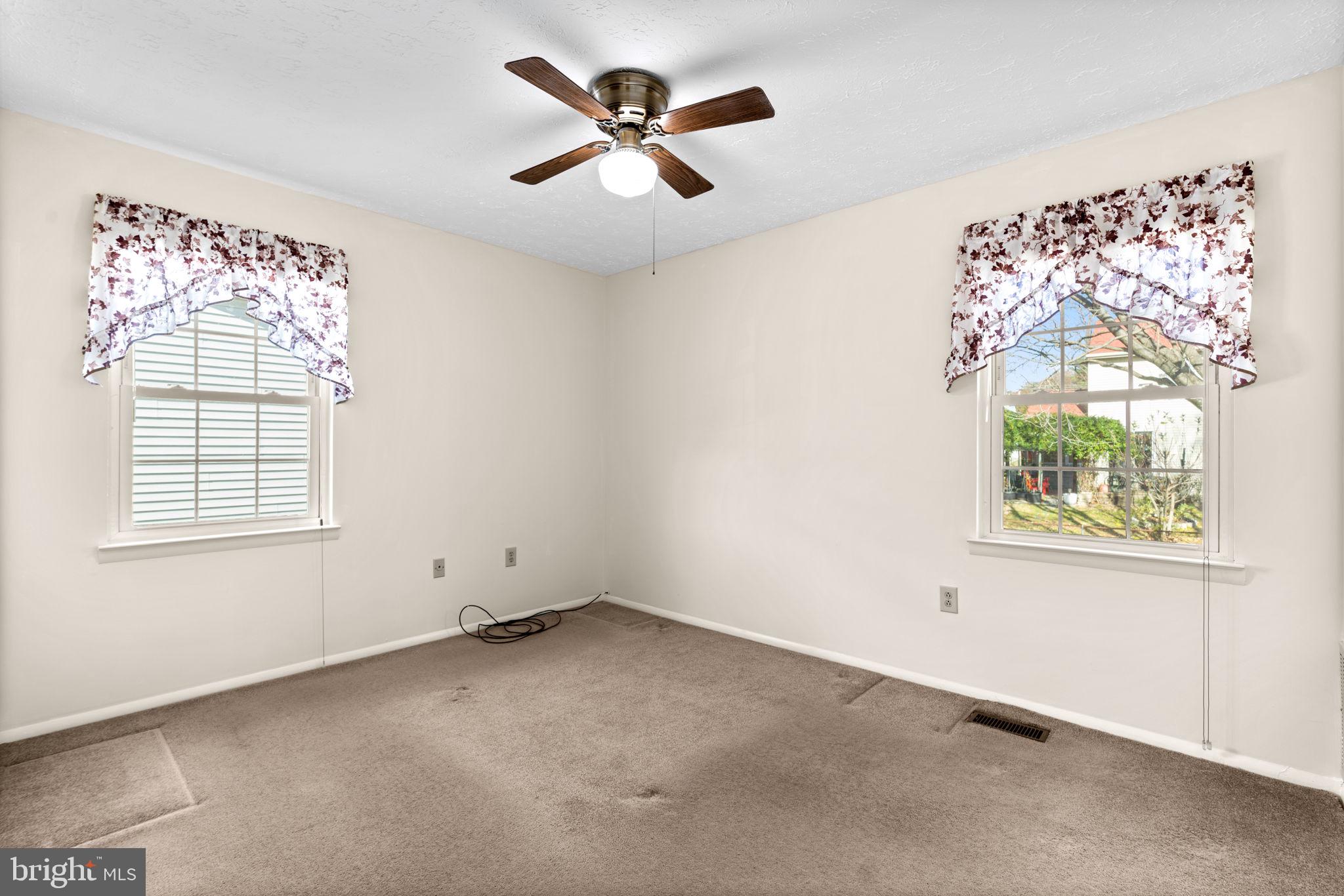 1818 Lasalle Place Severn, MD 21144 - Photo 15 of 30 an empty room with a window and a fan