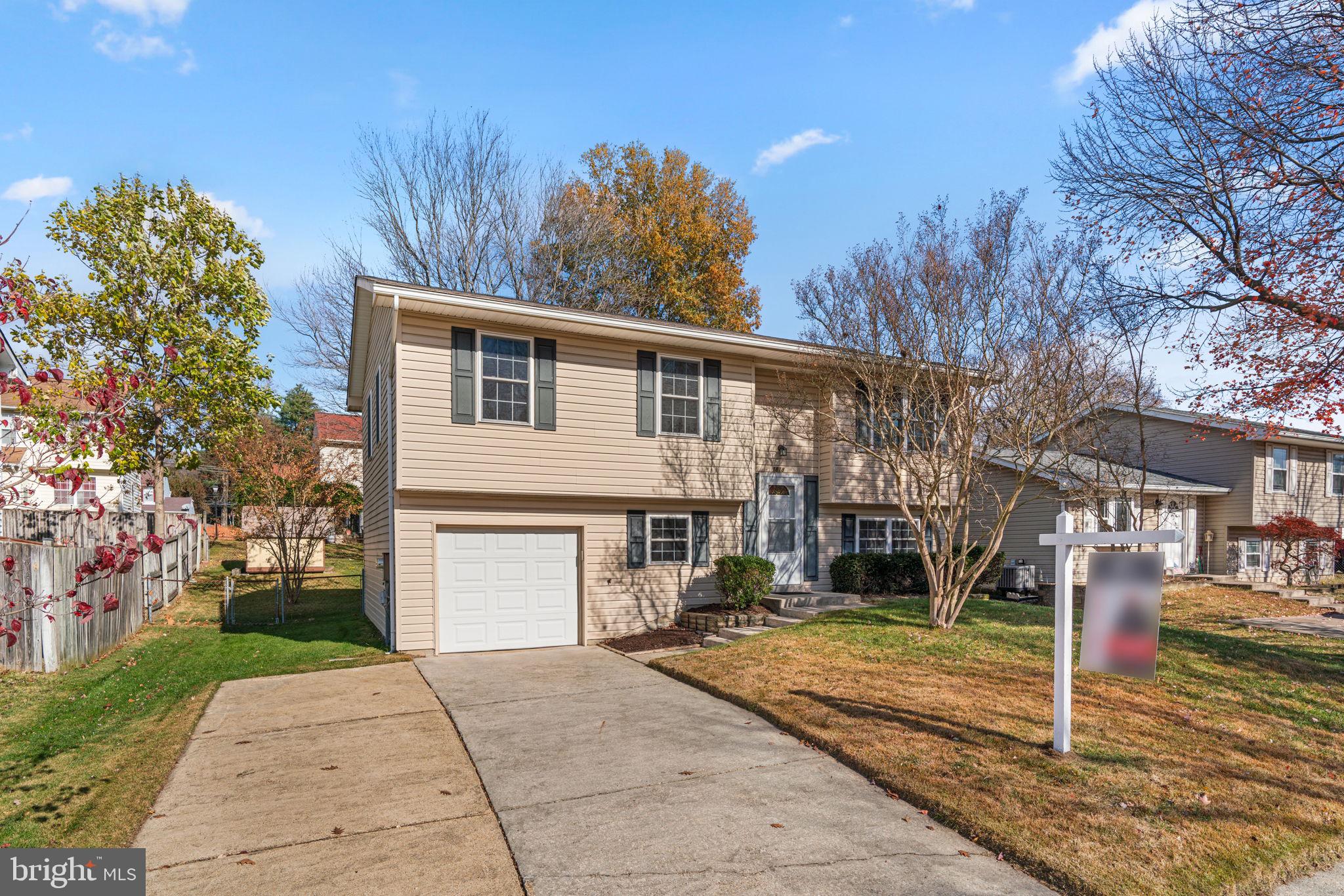 1818 Lasalle Place Severn, MD 21144 - Photo 2 of 30 a front view of a house with a yard and garage