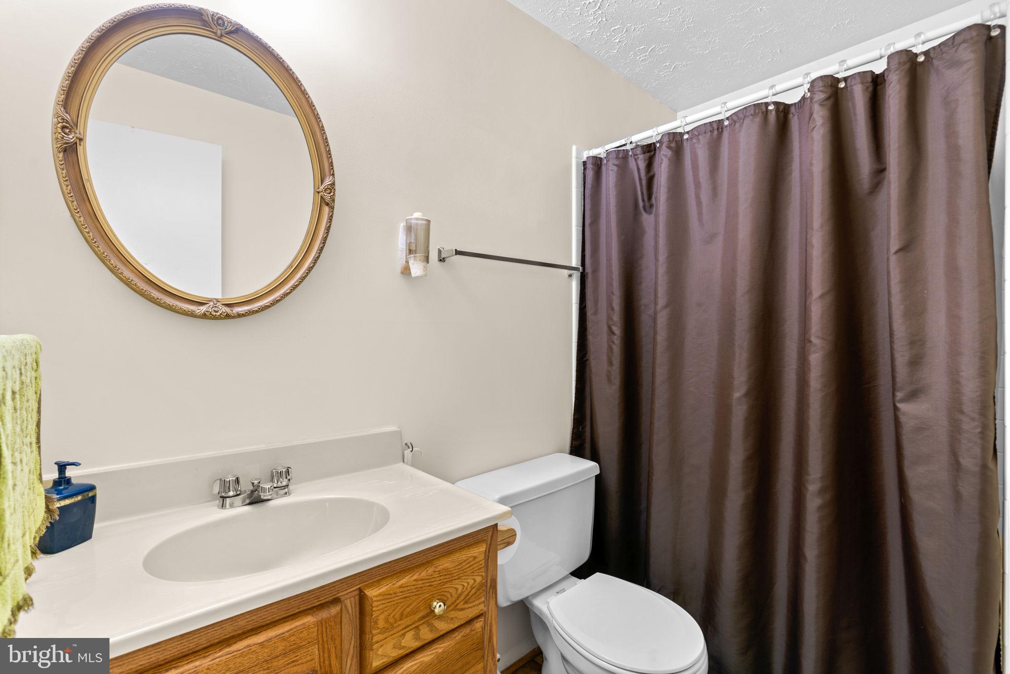 1818 Lasalle Place Severn, MD 21144 - Photo 23 of 30 a bathroom with a sink and a mirror