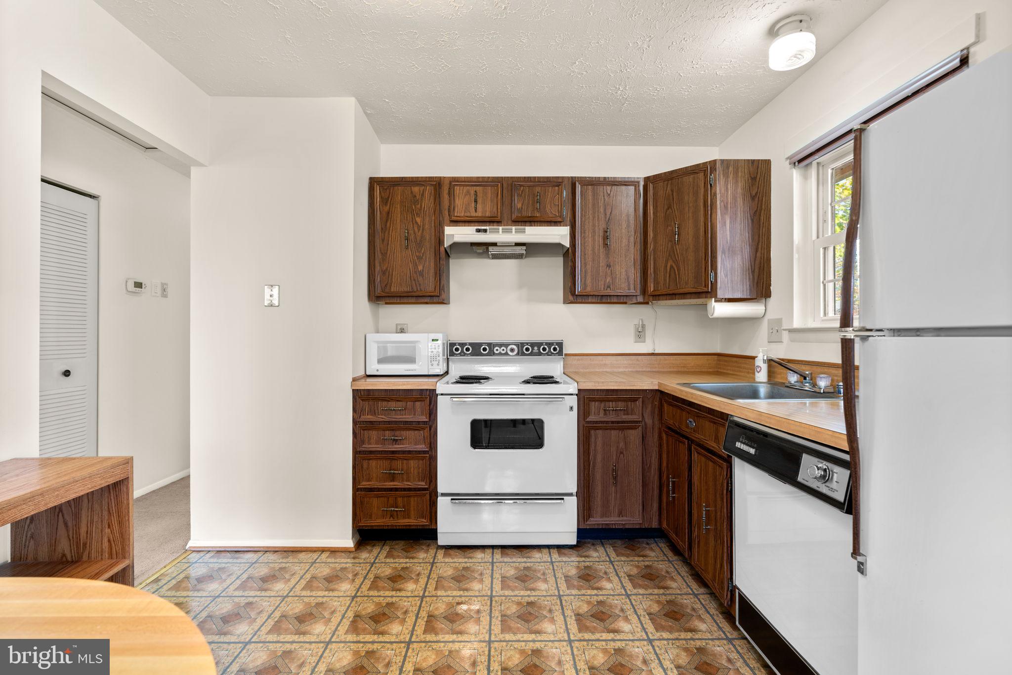 1818 Lasalle Place Severn, MD 21144 - Photo 9 of 30 a kitchen with a stove and a sink