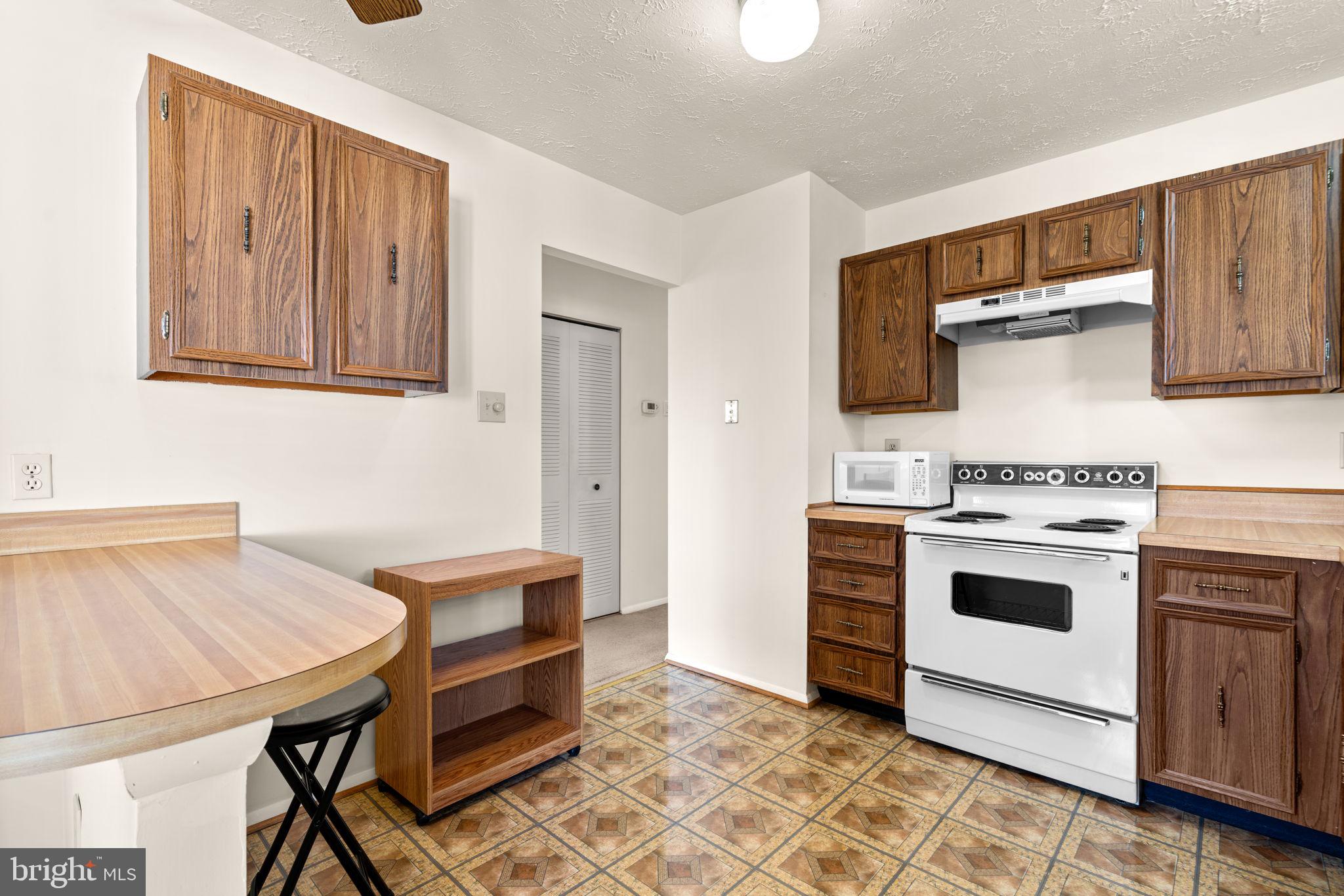 1818 Lasalle Place Severn, MD 21144 - Photo 10 of 30 a kitchen with a stove and a microwave