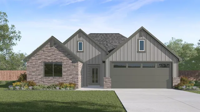 a front view of a house with a garden and yard