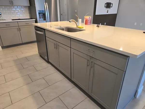 a kitchen with a sink and cabinets