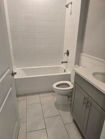 a bathroom with a toilet a sink and a bathtub