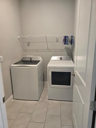 a view of a hallway with wooden floor and a cabinet