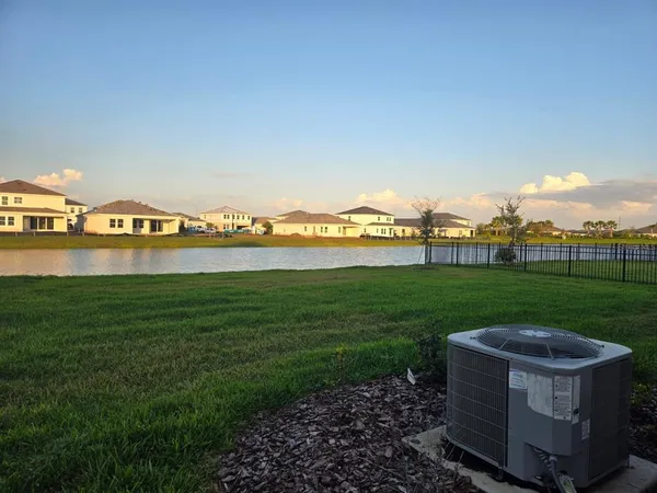 a view of a lake with houses in the back