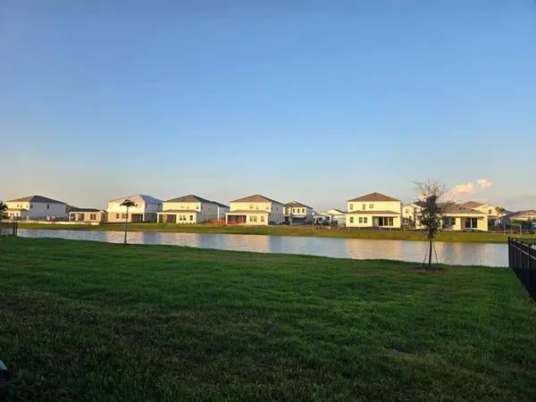 a view of a big yard with an buildings in the background