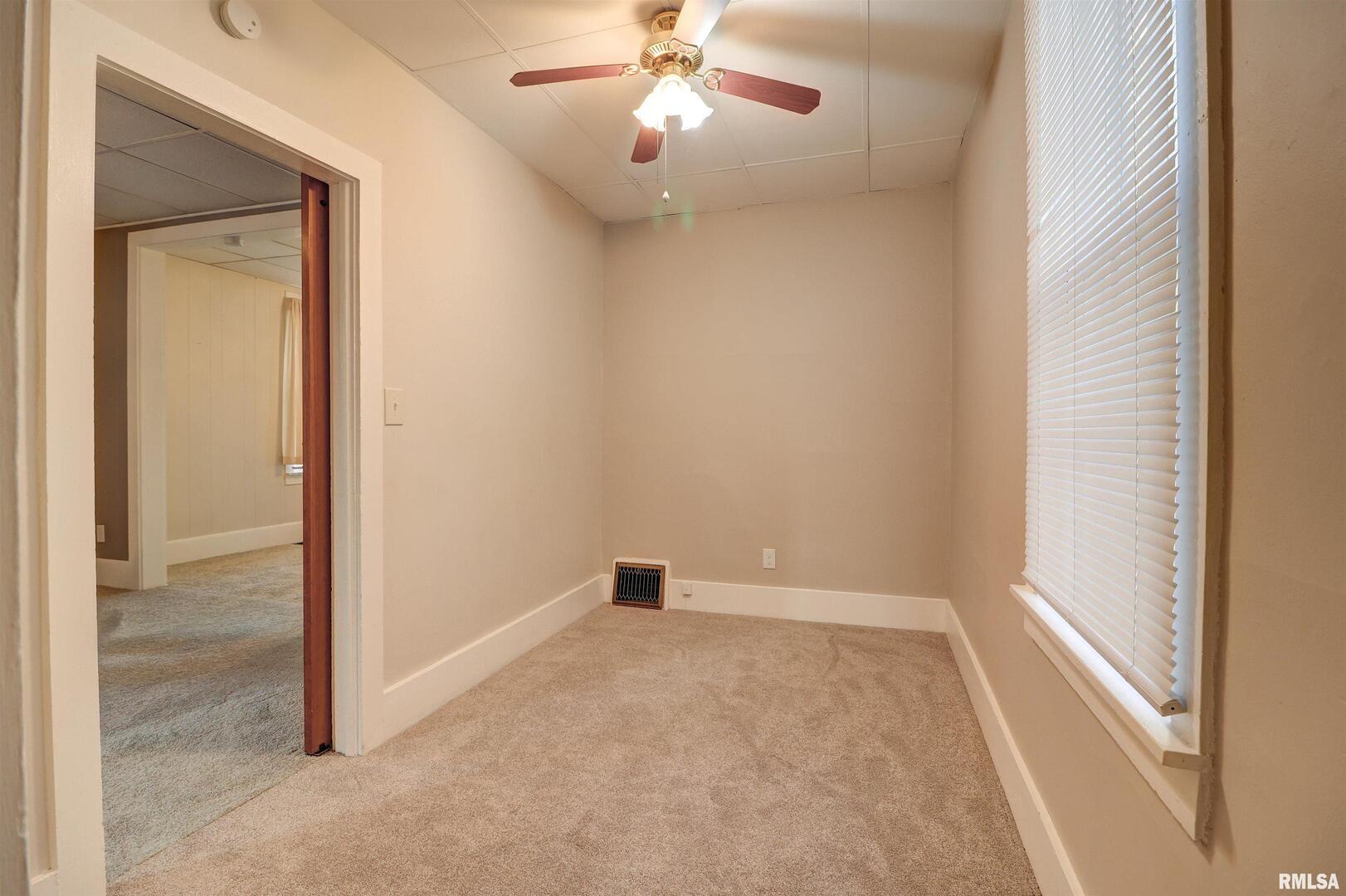 1913 Pershing Boulevard Clinton, IA 52732 - Photo 13 of 26 an empty room that has a window