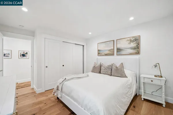 a bedroom with a bed and a painting on the wall