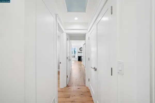 a view of a hallway with wooden shelves