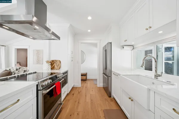 a kitchen with stainless steel appliances a sink stove and refrigerator