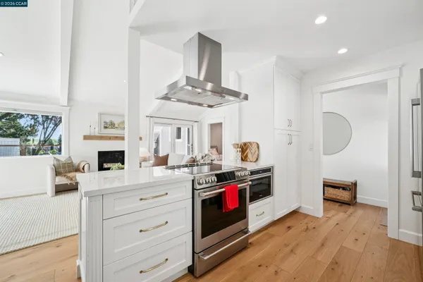 a kitchen with a stove and a white cabinets