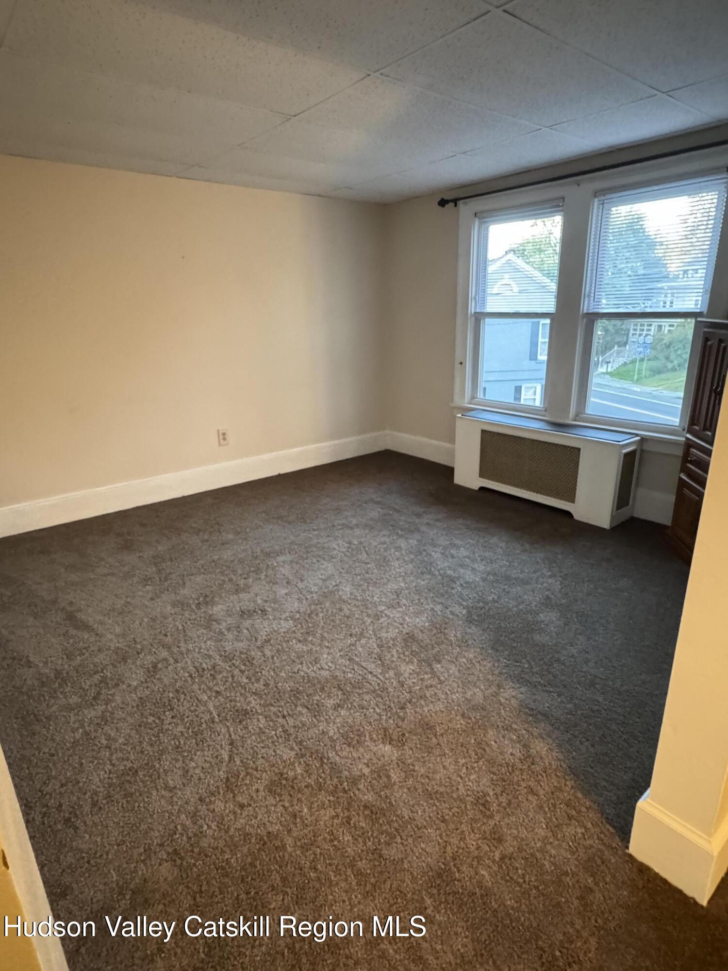 86 Ulster Avenue, Unit B Saugerties, NY 12477 - Photo 4 of 16 an empty room with windows