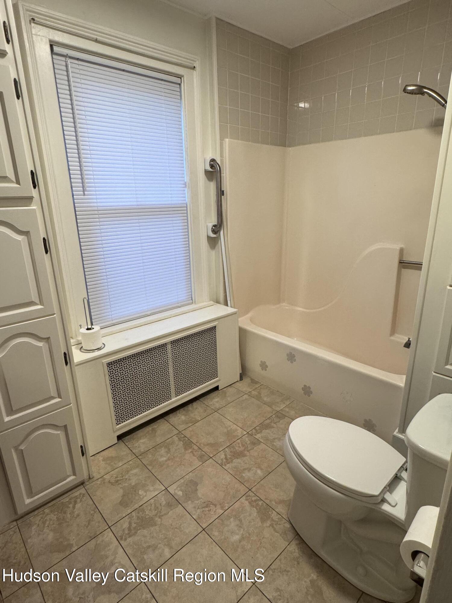 86 Ulster Avenue, Unit B Saugerties, NY 12477 - Photo 5 of 16 a bathroom with a toilet a sink and bathtub