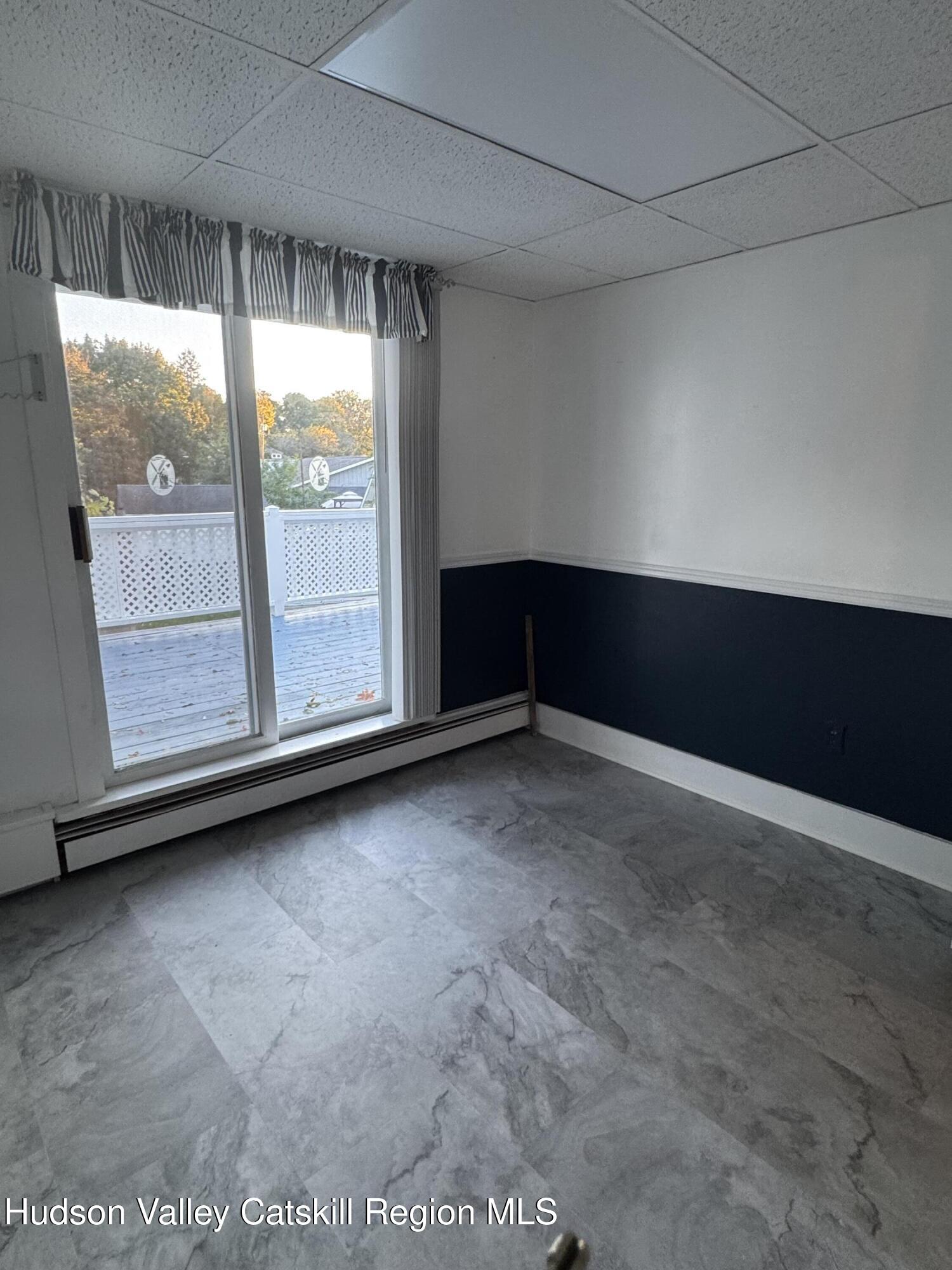 86 Ulster Avenue, Unit B Saugerties, NY 12477 - Photo 8 of 16 a view of an empty room with a window