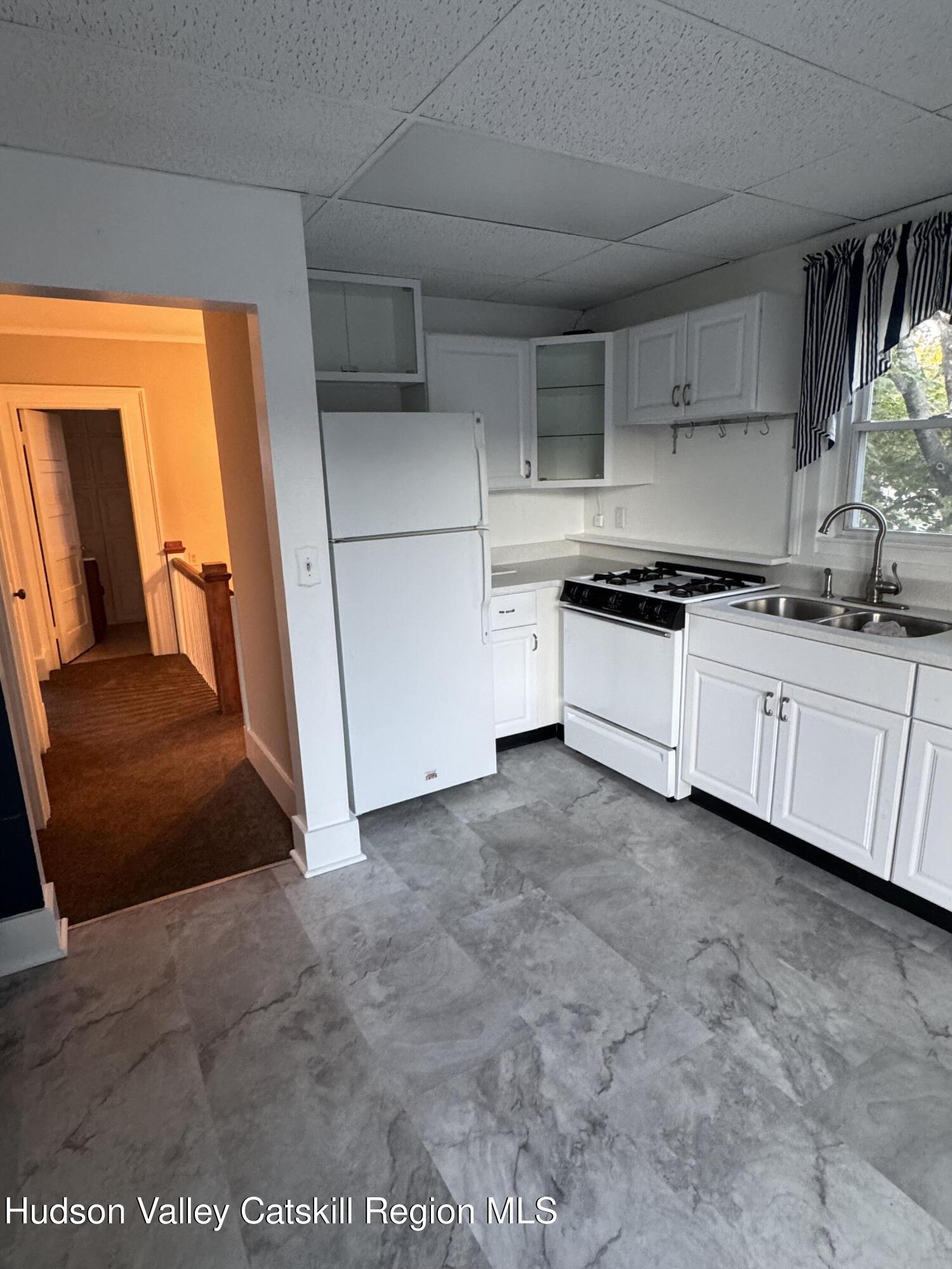 86 Ulster Avenue, Unit B Saugerties, NY 12477 - Photo 9 of 16 a kitchen with stainless steel appliances granite countertop a sink and cabinets