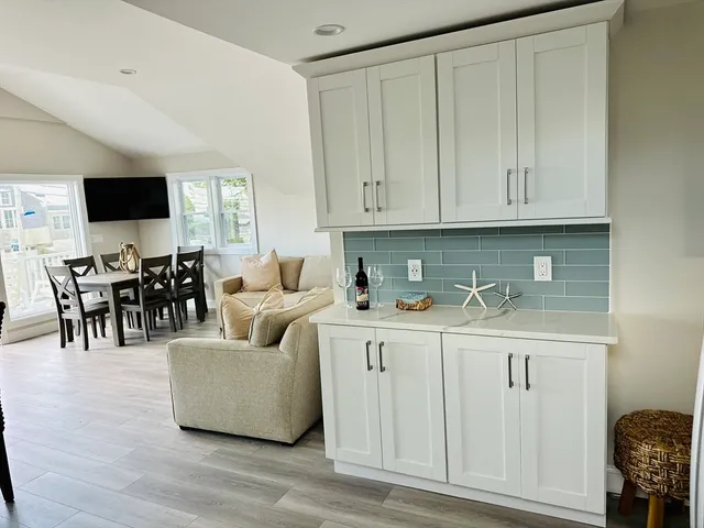 a living room with white cabinets and a couch