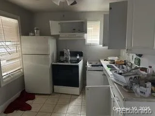 a kitchen with a refrigerator and a stove