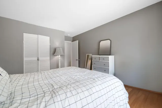 a large bed in a bedroom with a mirror