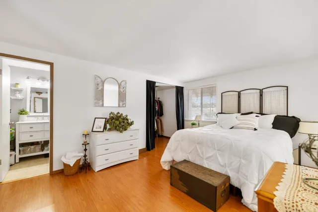 a bedroom with a bed and dresser