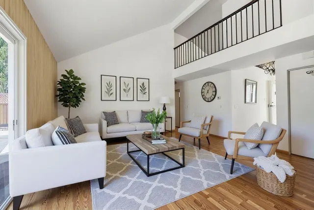 a living room with furniture and wooden floor