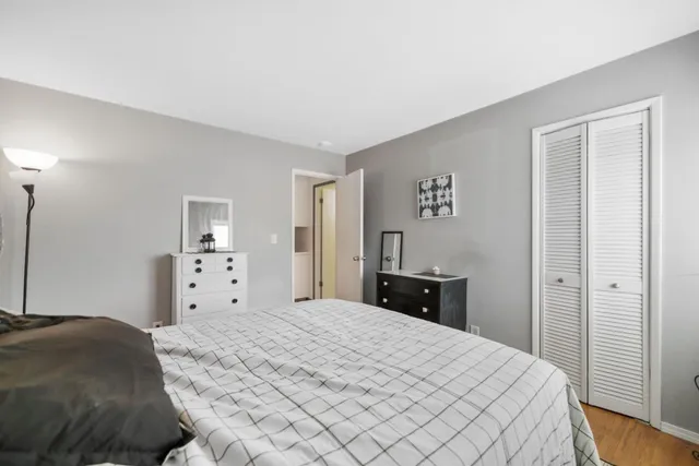 a bedroom with a bed and a closet