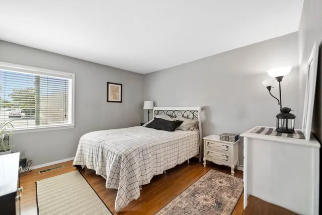 a bedroom with a bed and a window