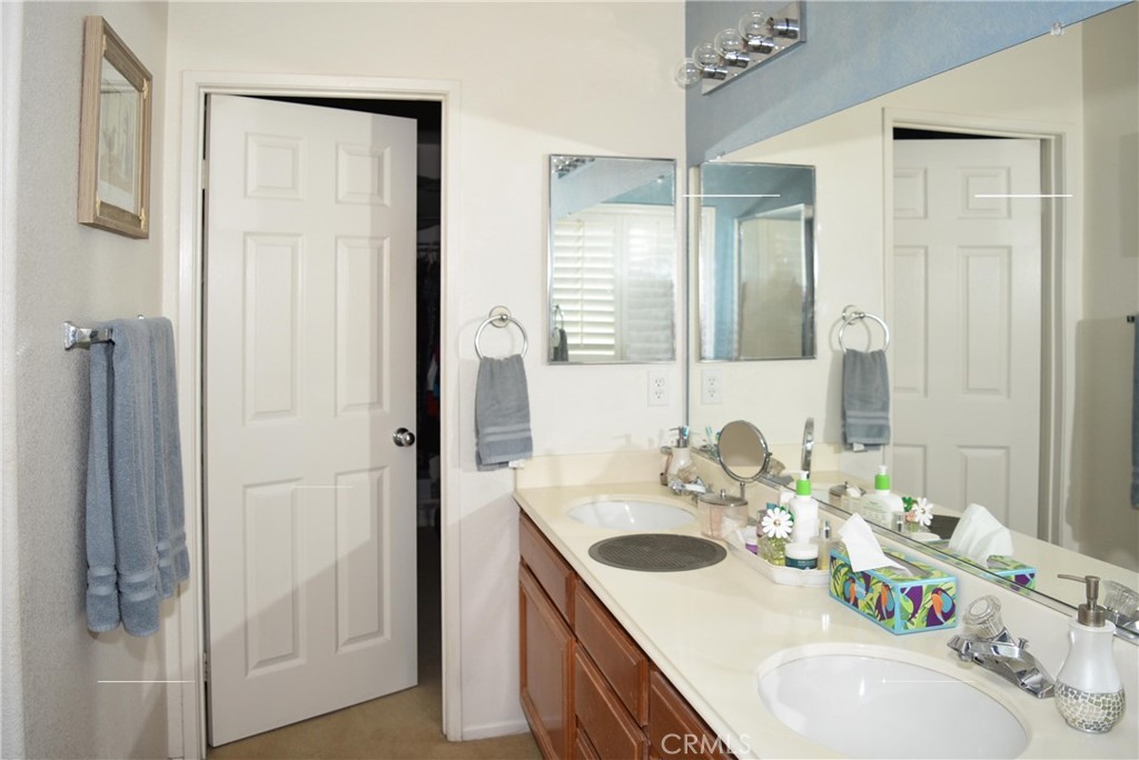 1665 Ravenswood Road Beaumont, CA 92223 - Photo 28 of 41 a bathroom with a sink and a mirror