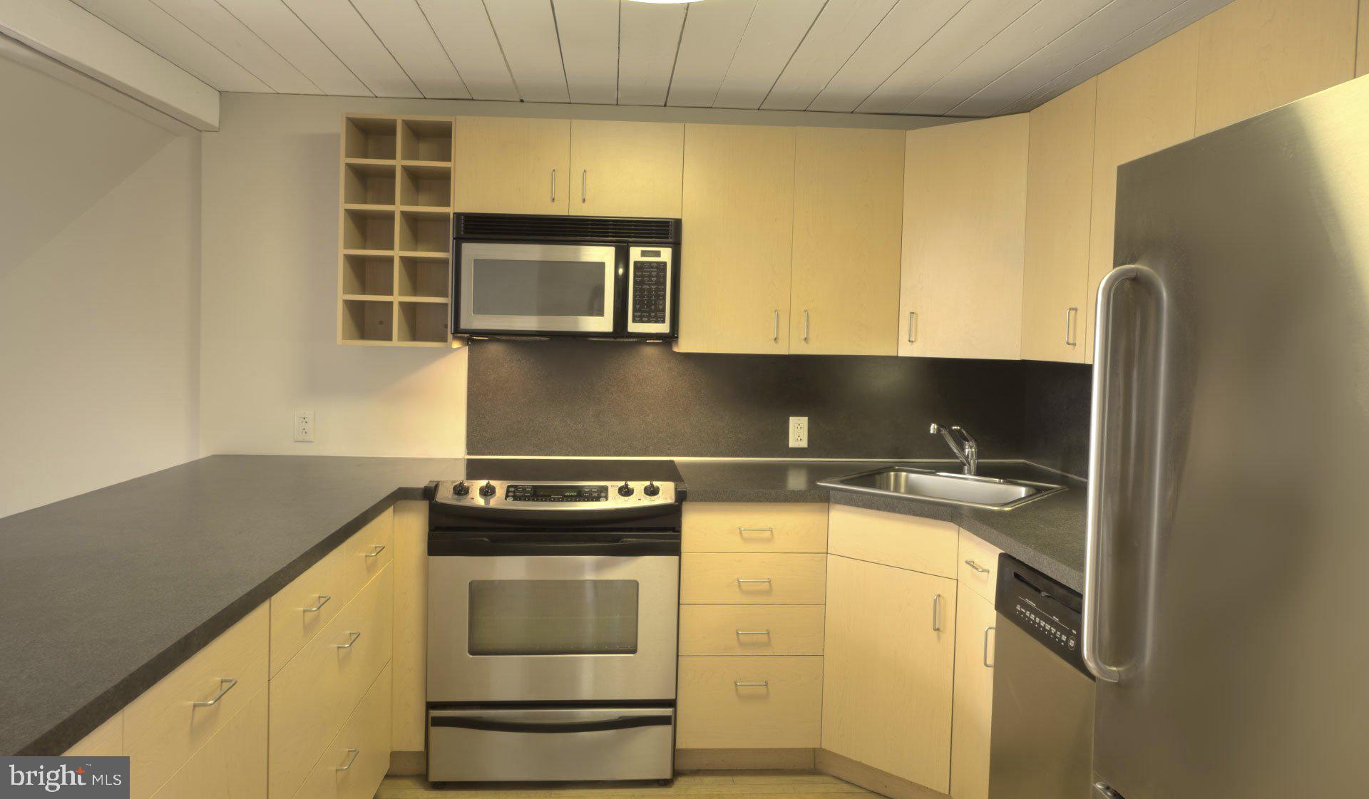 2300 Walnut Street, Unit 228 Philadelphia, PA 19103 - Photo 26 of 27 a kitchen with a sink and a stove