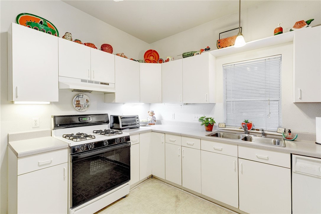604 Fletcher Street Austin, TX 78704 - Photo 14 of 35 a kitchen with cabinets a sink and appliances