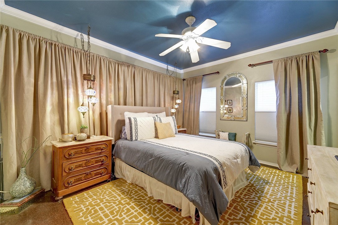 604 Fletcher Street Austin, TX 78704 - Photo 25 of 35 a bedroom with a bed and a chandelier