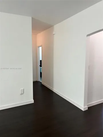 an empty room with wooden floor