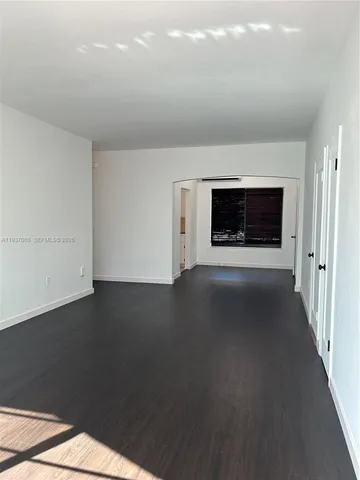 a view of a livingroom with an empty space and a fireplace