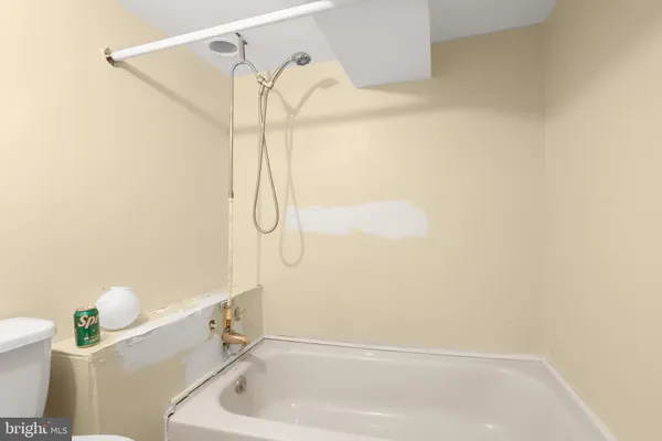 a bathroom with a shower a toilet and sink
