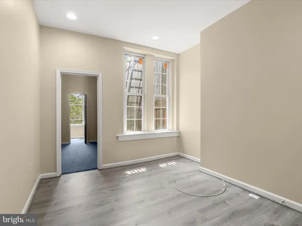 a dining room with furniture and a refrigerator
