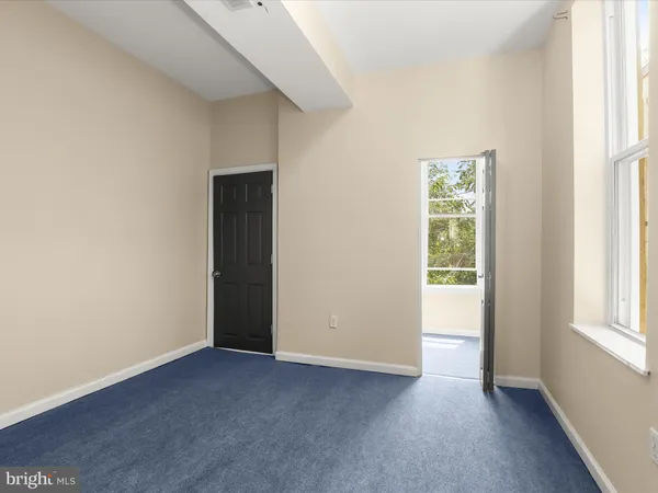 a bathroom with a toilet and a shower curtain