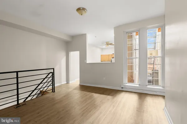a view of a livingroom with a window and a ceiling fan
