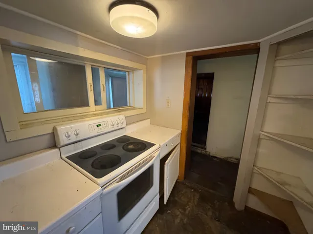 a view of empty room with wooden walls