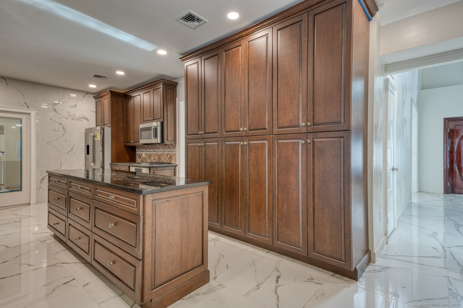 171 Oregon Road Meriden, CT 06451 - Photo 13 of 38 a kitchen with stainless steel appliances granite countertop wooden cabinets a sink and a refrigerator