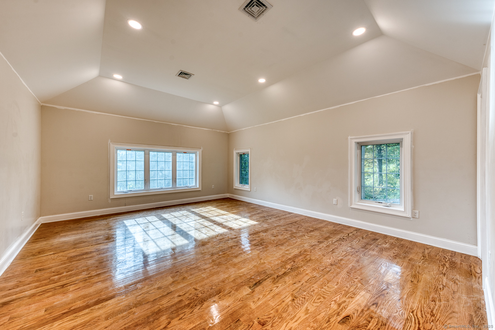 171 Oregon Road Meriden, CT 06451 - Photo 22 of 38 an empty room with wooden floor and windows