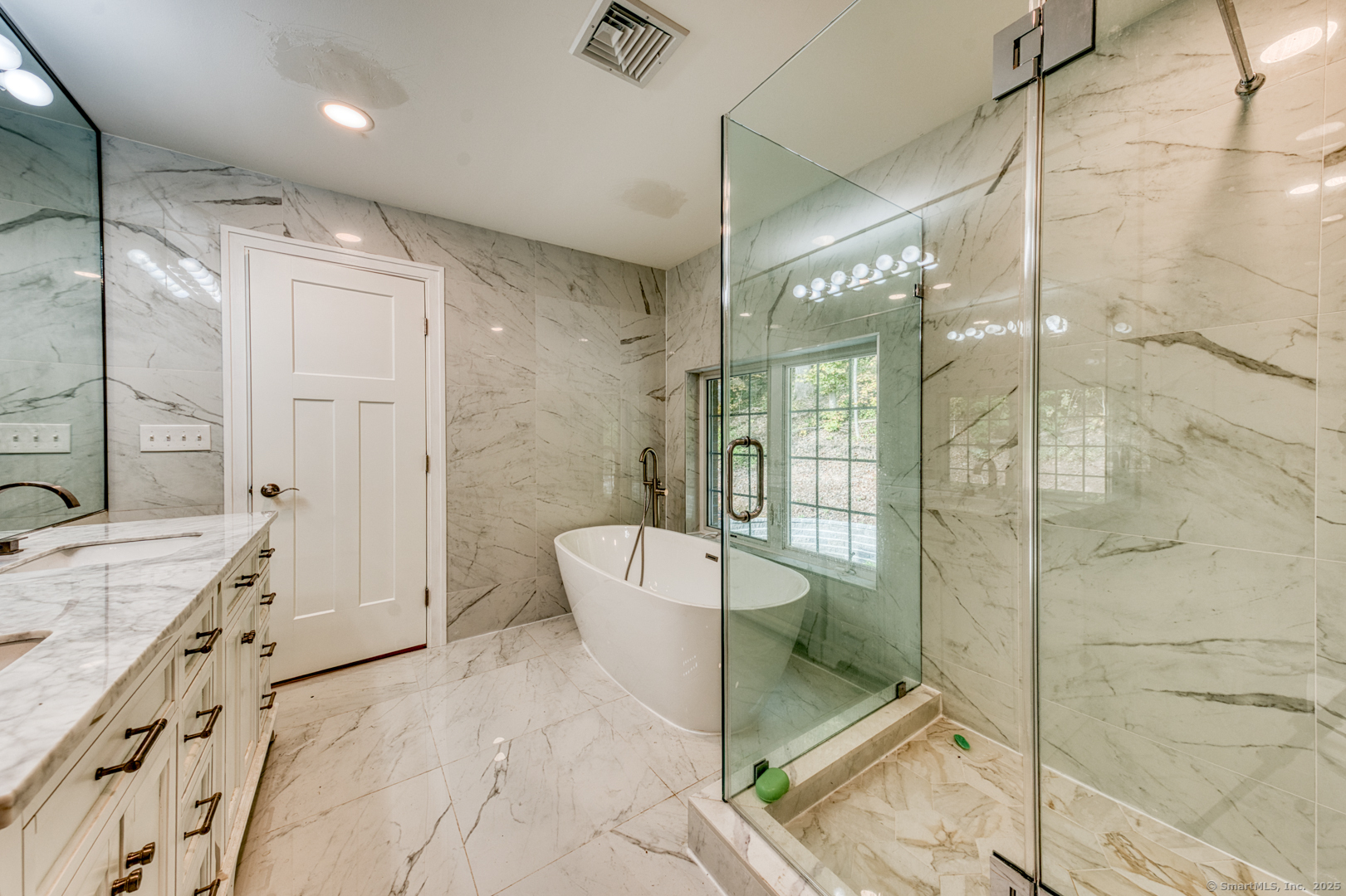 171 Oregon Road Meriden, CT 06451 - Photo 28 of 38 a spacious bathroom with a double vanity sink toilet mirror and bathtub