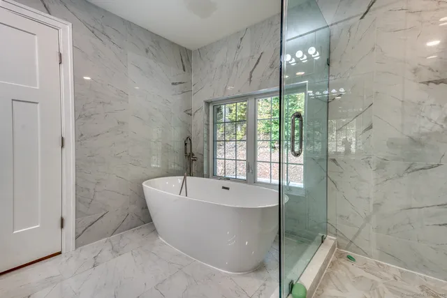 a bathroom with a bathtub and shower