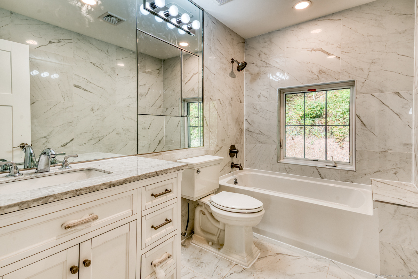 171 Oregon Road Meriden, CT 06451 - Photo 30 of 38 a bathroom with a granite countertop sink toilet mirror and bathtub
