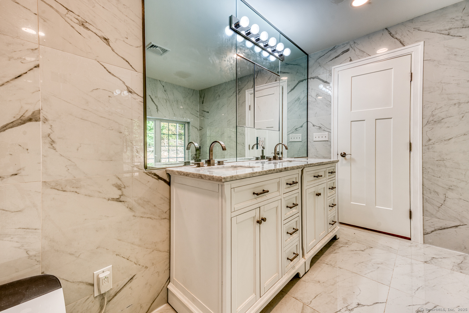 171 Oregon Road Meriden, CT 06451 - Photo 32 of 38 a bathroom with a double vanity sink a mirror and a shower