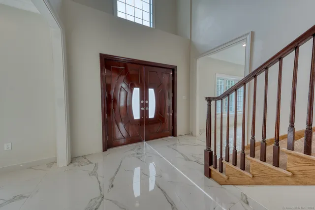 a view of a hallway with wooden floor and stairs