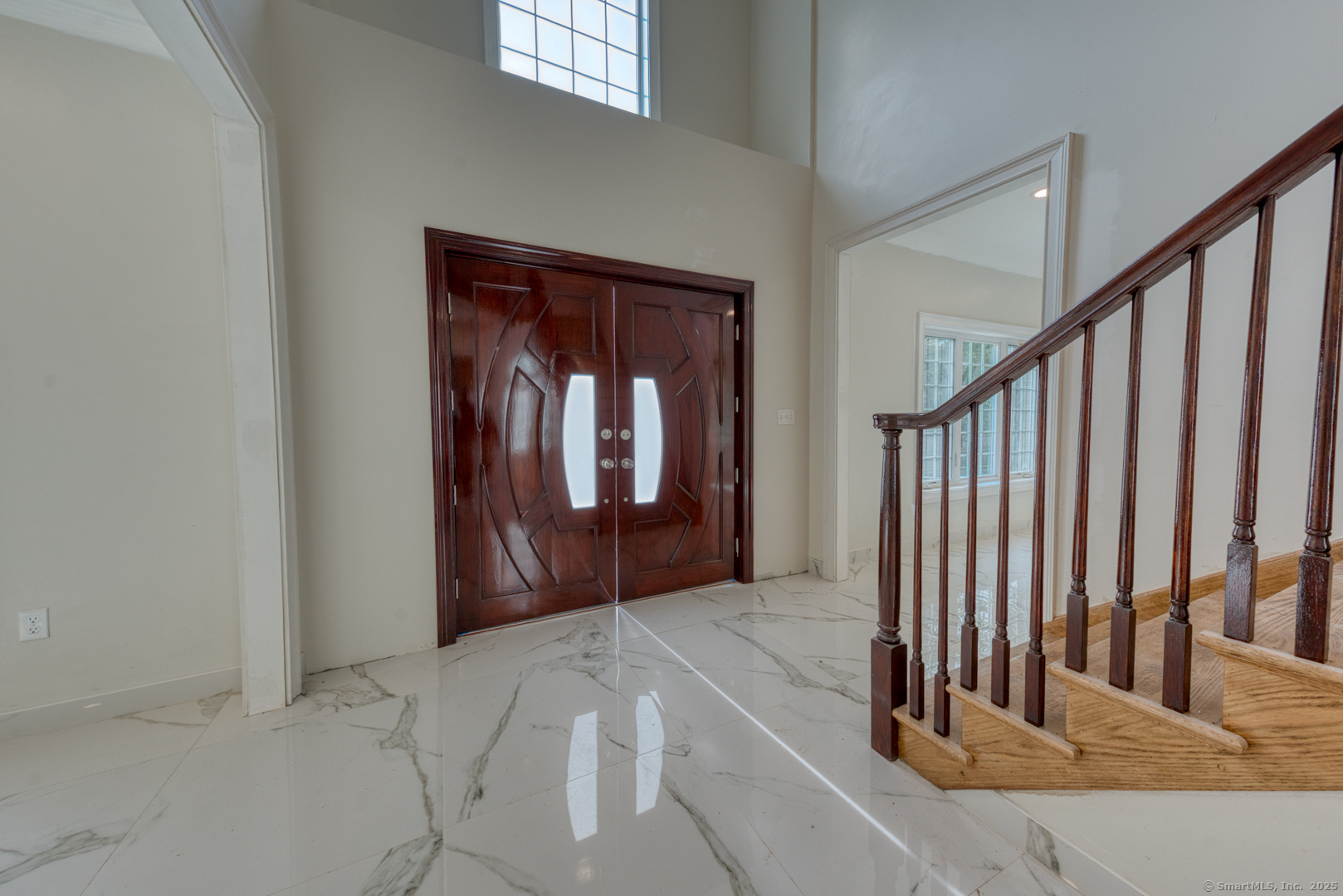 171 Oregon Road Meriden, CT 06451 - Photo 6 of 38 a view of a hallway with wooden floor and stairs